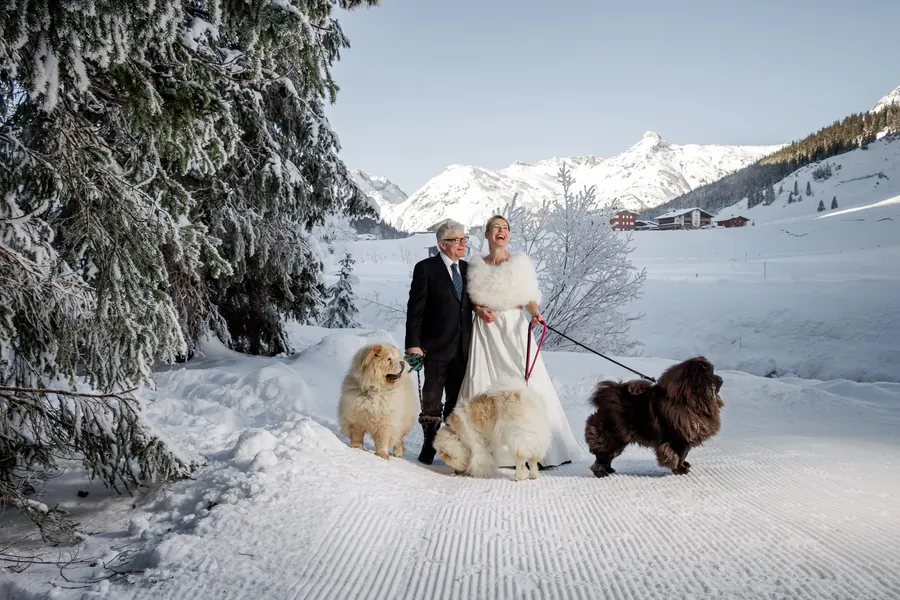 Brautpaar mit drei Hunden im Schnee, Winterhochzeit in Lech am Arlberg